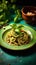 Ceramic plate with hazelnut pesto spaghetti on green table surface