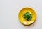 Ceramic plate with microgreen arugula sprouts isolated on wooden background. Top view, close-up. Microgreens, healthy