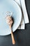 Ceramic plate, porridge, wooden spoon, napkin. Porridge in a wooden spoon and ceramic plate. Ingredients for healthy breakfast