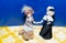 ceramic porcelain dolls in vintage dress. dolls standing on the blue and yellow background. Vintage LGBT lesbians concept