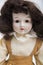 Ceramic porcelain handmade doll with long brunette hair and beige dress