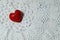 Ceramic red heart on white lace knitted fabric. Crochet Favorite hobby, Valentine.