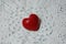 Ceramic red heart on white lace knitted fabric. Crochet Favorite hobby, Valentine.