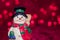 Ceramic snowman on red bokeh background