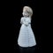 Ceramic statuette of a little girl isolated on black background.