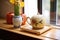 a ceramic teapot and cup set on a bamboo tray in a cozy nook