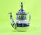 Ceramic teapot isolated on green background morocco