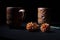 Ceramic terra cotta tea cups with dry flowers in black background.