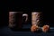 Ceramic terra cotta tea cups with dry flowers in black background.