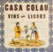 Ceramic tile informing about the sale of wines and spirits of Casa Colau