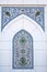 ceramic tile with a traditional oriental Uzbek floral ornament with a arabic pattern. Wall of white mosque Minor in