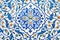 ceramic tile with a traditional Uzbek floral ornament with a pattern of flowers. The wall of white mosque Minor in