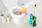 Ceramic toilet bowl, bottles of detergent