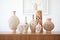 ceramic vases with intricate carvings in a pottery barn