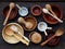 Ceramic, wooden, clay empty handmade bowl, cup and spoon on dark background. Pottery earthenware utensil, kitchenware.