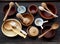 Ceramic, wooden, clay empty handmade bowl, cup and spoon on dark background. Pottery earthenware utensil, kitchenware.