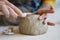 Ceramics creation process: female artist shaping and sculpting clay pottery. Working table in studio