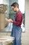 Ceramist Dressed in an Apron Setting the Electric Oven for Drying the Clay Sculpture Using Control Console.