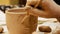 Ceramist is modeling clay pot or vase bowl