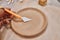 A ceramist in a pottery workshop makes patterns on a clay plate using tools.