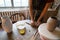 Ceramist in studio shaping clay details from wet earthenware during art master class in workshop