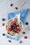 A cereal breakfast with berries and nuts