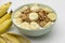 Cereal flake with pieces of banana fruits slice in the blue bowl