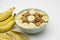 Cereal flake with pieces of banana fruits slice in the green bowl