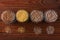 Cereal grains in glass jars on wooden background. Collection of different groats top view barley, oats, millet and wheat