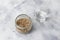 Cereal mixture for healthy keto crackers of chia seeds, flax, sesame, ground pumpkin seeds in a glass jar on a gray background