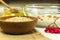 Cereal uncooked flakes in wooden bowl. Barley flake porridge with milk, honey, guelder rose and walnuts. Healthy, organic food.