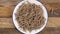 Cereal wheat fiber sticks. Dry healthy bran flake. Close up. Falling on a plate in slow motion.