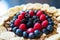 Cereals and fruits superbowl, healthy bowl breakfast with flakes, oat and fruits: raspberries, blueberries, banana, blackberries