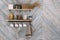 Cereals in glass jars on shelf, white cups, towel hang on hooks on kitchen wall