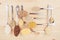 Cereals grains collection in silver spoons on white wood background.