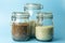 Cereals oatmeal, buckwheat, rice in glass jars in the kitchen. Gluten free concept. Varieties of cereals for making healthy