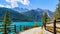 Ceresole Reale, Italy. View of Lake Ceresole on a sunny summer day. A family walks along the path. Alps mountains in the