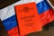 Certificate of Soviet Union serviceman and Russian flag on table