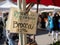 Certified organic broccoli and price sign hanging on a farmers market tent