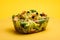 Cesar Salad tasty fast food street food for take away on yellow background