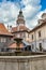 Cesky Krumlov castle tower and a fountain, famous touristic destination