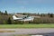 Cessna flies over the runway