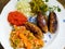 Cevapcici with ajvar, cucumbers, onions and Djuvec rice,