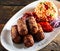 Cevapcici minced beef rolls with vegetables