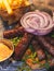 Cevapi on a plate, traditional balkan dish, grilled minced beef meat, Cevapcici, with onion and french fries served in restaraunt