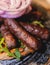 Cevapi on a plate, traditional balkan dish, grilled minced beef meat, Cevapcici, with onion and french fries served in restaraunt