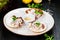 Ceviche. Finely chopped raw squid marinated in lemon juice served in seashell