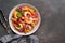 Ceviche in a plate on a dark rustic background. Latin American food. Top view, flat lay, copy space