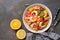 Ceviche salad with shrimps and oranges on a dark rustic background. Latin American food. Top view, flat lay, copy space