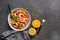 Ceviche salad with shrimps and oranges on a dark rustic background. Latin American food. Top view, flat lay, copy space